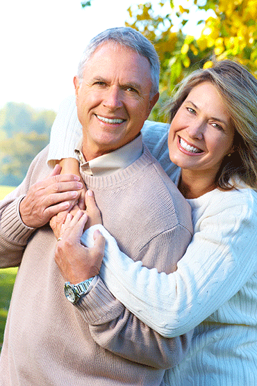 older couple enjoying benefits of dental implants